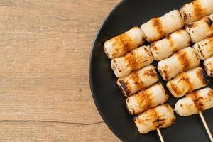 Grilled tube-shaped fish paste cake or tube squid skewer on plate photo
