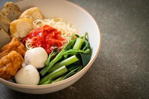 Egg noodles with fish balls and shrimp balls in pink sauce, Yen Ta Four or Yen Ta Fo - Asian food style photo