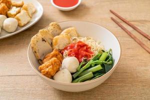 Egg noodles with fish balls and shrimp balls in pink sauce, Yen Ta Four or Yen Ta Fo - Asian food style photo