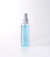 Blue alcohol bottle spray isolated with clipping path photo