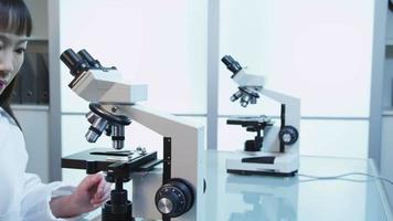 Scientist looks into microscope video