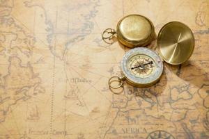 Old compass on vintage map photo