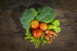 Green vegetables on wood background photo