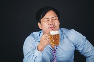 Cropped close up of a man drinking beer at the home photo