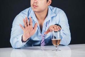 Handsome handsome man drinking whisky at home photo