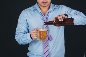 Cropped close up of a man drinking beer at the home photo