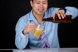 Cropped close up of a man drinking beer at the home photo