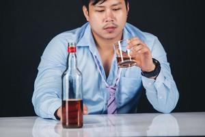 Handsome handsome man drinking whisky at home photo