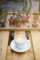 Hot latte art on wood table background photo