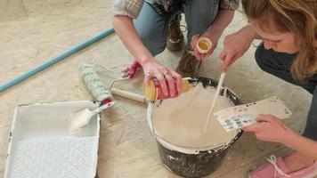 Beige Paint Being Mixed Together