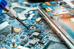 technician repairing inside of hard disk by soldering iron photo