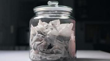 A glass jar full of teabags macro photography photo