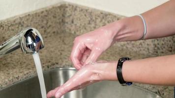 Woman washing her hands with sanitizer photo
