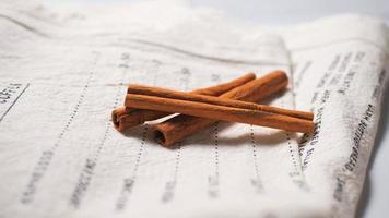 Cinnamon sticks on recipe cloth photo