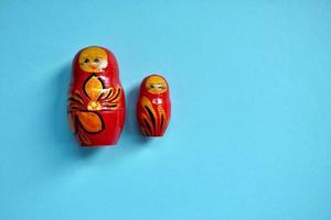 red matrioshka doll on the blue background photo