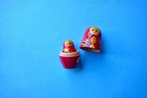 red matrioshka doll on the blue background photo