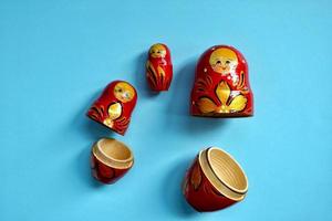 red matrioshka doll on the blue background photo