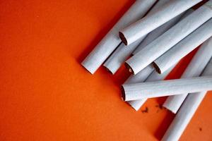 cigarette tobacco on the orange background photo