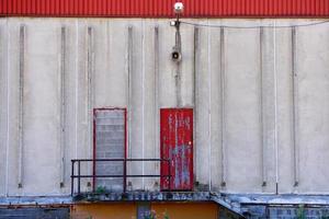 red metallic door on the building photo