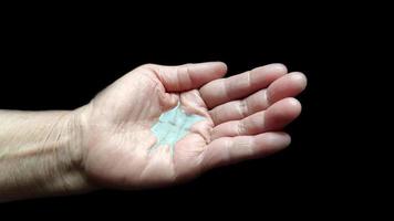 Hand of the elderly woman with alcohol gel photo