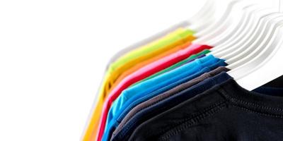 Close Up of t shirts  Clothes on hangers on white background photo