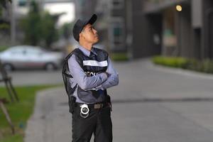 Security man standing outdoors near big building photo