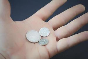silver coins in hand photo