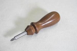 screwdriver with wooden handle on white background copy space photo