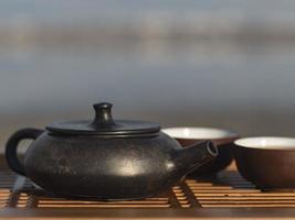 Vintage chinese set with black tea ceremony yixing teapot on green background photo
