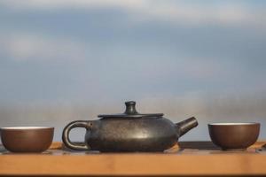 Vintage chinese set with black tea ceremony yixing teapot on green background photo