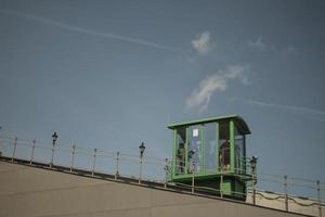 green funicular with tourists goes up photo