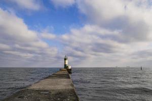 lighthouse on a pier at sea a symbol of hope photo