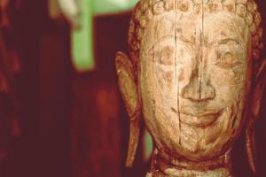 A wooden buddha head sculpture statue background photo