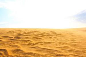 Wave on desert and blue sky Mui Ne sand dune at South Vietnam photo