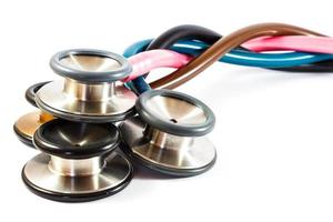 twist colorful stethoscopes on white background  isolated  and blank area at right side photo