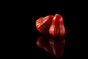 Rose apple on black acrylic photo