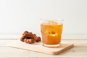 Delicious sweet drink tamarind juice and ice cube photo