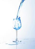 Blue drink splash into wine glass photo