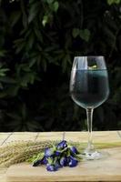 Iced blue drink with butterfly pea flowers photo