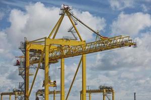 Large industrial cranes loading container ship in Dublin Port in Ireland photo