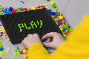 Kid playing pinning board game photo