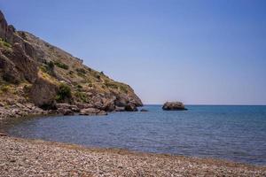 Seascape with rocks on the background of water photo