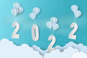 arte de papel feliz año nuevo 2022 con espacio para su texto temporada de invierno sobre fondo de cielo azul vector