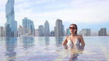 Asian woman relax and enjoy around outdoor swimming pool video