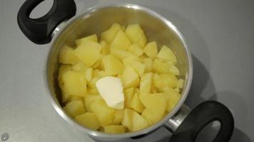 Boiled potatoes with butter in a saucepan video