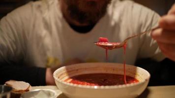 man with a beard eating borsch video