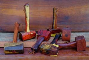 Set of mallet hammer wood made of rosewood tool handmade of Thailand for used by a carpenter in the workshop on the old workbench photo