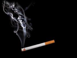 Close up of a cigarette with smoke showing photo