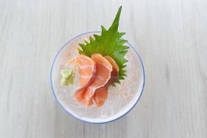 Salmon slice or salmon sashimi in Japanese style fresh serve on ice with fresh wasabi photo