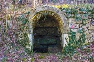 Water source with stone arch photo